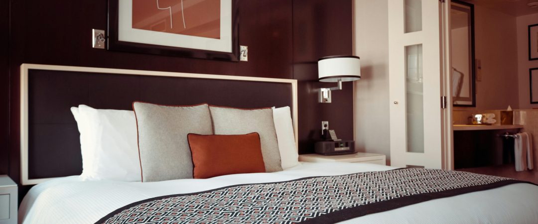 Cozy and modern hotel bedroom interior with elegant decor and soft lighting.