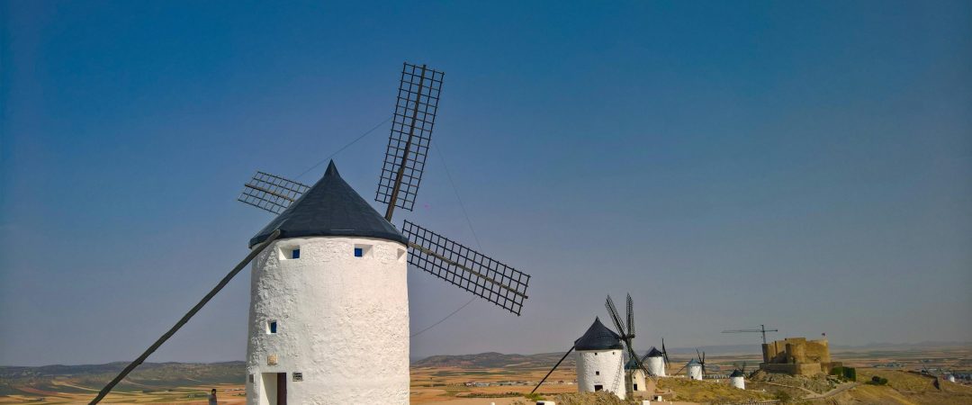 Capture of the historic windmills in Consuegra, Spain, under a clear sky.
