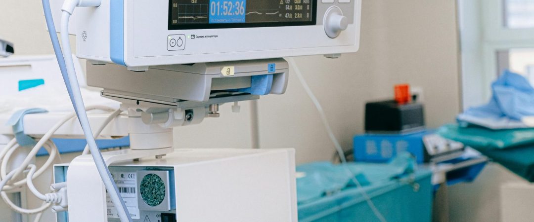 Close-up of vital signs monitor in a modern operating room setup.